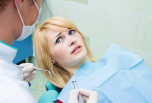 scared woman in dentist chair